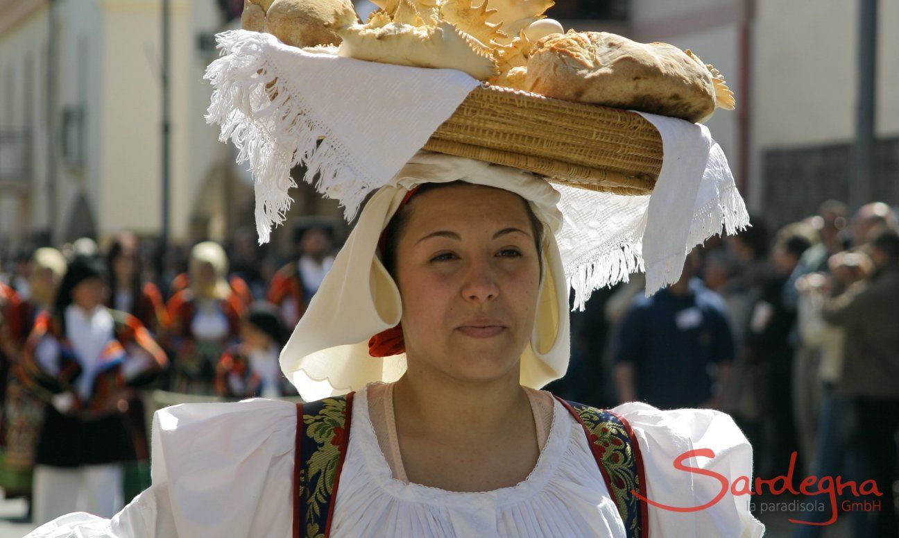 Donna in constume sardo porta pane in testa