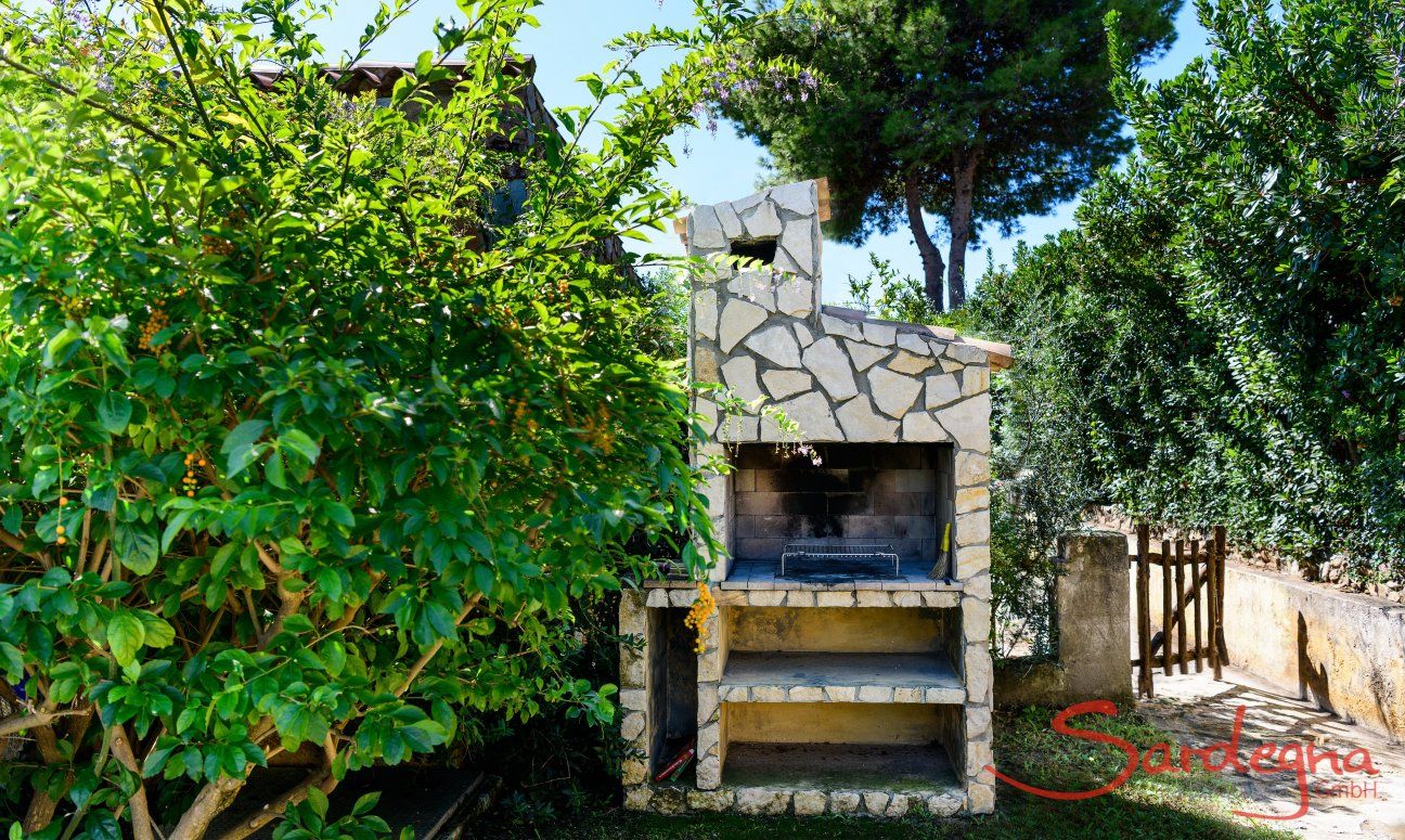 Casa Meloni 2 | Grande barbecue murato nel giardino Barbecue in muratura nel giardino di Meloni 2 a Sant Elmo