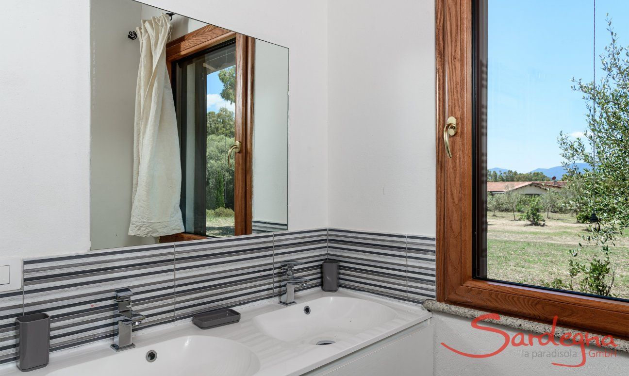 Villa Isabelle | Bagno 2 con due lavandino e vista giardino Villa Isabelle, Torresalinas