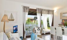 Villa Campidano 8 | Sala diviso in zona relax e zona cucina Salotto