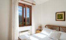 Villa Tiziana 11 | Camera 1 con letto matrimoniale e vista nel verde giardino Rittratto della casa